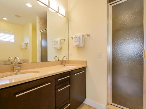 a bathroom with two sinks and a shower at Island Pearl by Sun Palace Vacations in Fort Myers Beach
