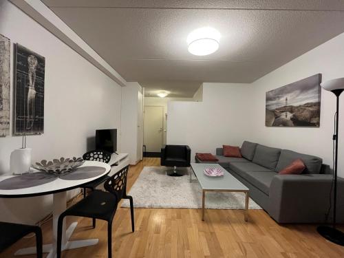 a living room with a couch and a table at Peaceful Seaside Home - Sauna, Balcony, Wi-Fi in Helsinki