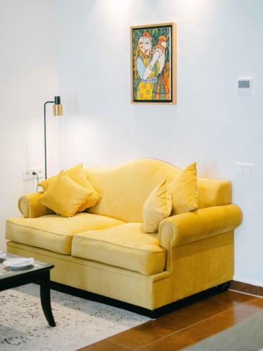 a yellow couch sitting in a living room at Tikida Golf Palace in Agadir