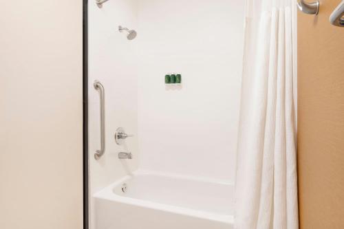 a bathroom with a shower with a white shower curtain at Fairfield Inn & Suites by Marriott Salt Lake City Downtown in Salt Lake City