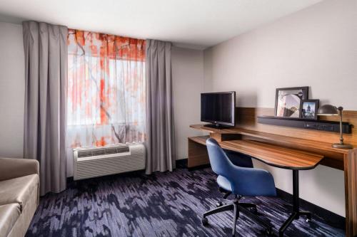 a hotel room with a desk with a computer and a chair at Fairfield Inn & Suites by Marriott Salt Lake City Downtown in Salt Lake City