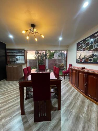 a conference room with a table and red chairs at Casa Huertos CIENEGUILLA in Cieneguilla