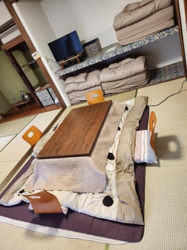 a living room with a wooden table and a couch at Fun stay大島 の1棟貸し宿 in Suo Oshima