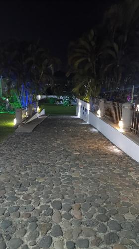 a stone walk way at night with lights at Hotel Iguanas in Yautepec
