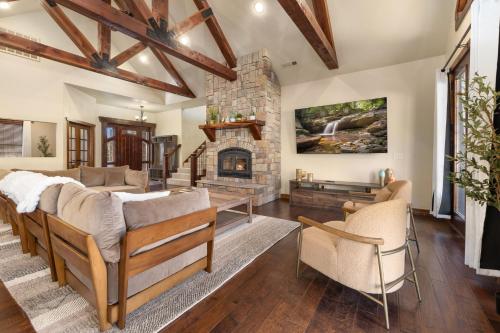 a living room with a couch and a fireplace at Whispering Brook in Springdale