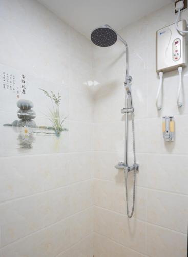 a shower in a bathroom with a shower head at Arista Villa in Ukulhas