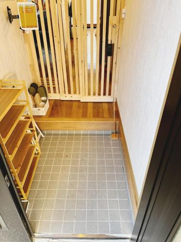 a room with a door and a staircase with a floor at たび宿Yumiashi in Sendai