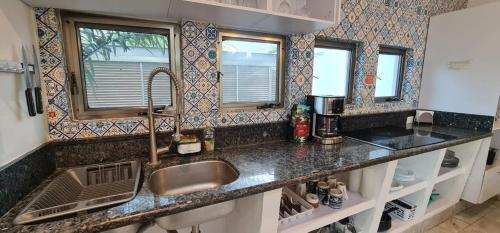 a kitchen with a sink and a counter top at Casa La Ceiba in Cancún