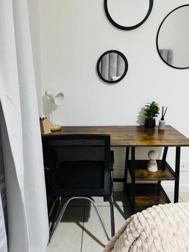a desk in a room with mirrors on the wall at Bee and Tees Cozy Retreat in Antwerp