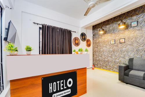 a hotel lobby with a reception desk and a couch at Hotel O Cheranelloor Aster Medicity Formerly Abriz Residency in Cochin
