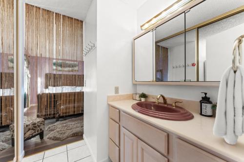 a bathroom with a sink and a mirror at Colorful and Cozy Haven with Heated Pool in Rodeo