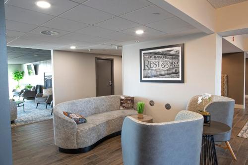 a waiting room with a couch and chairs at Holiday Inn St Louis SW - Route 66 by IHG in Saint Louis