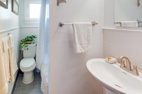 a white bathroom with a toilet and a sink at 1 Mi to Old Town Historic Area Gem in Alexandria in Alexandria