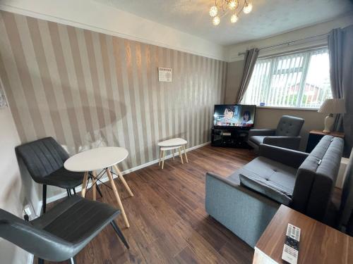 a living room with a couch and a table at Comfy One Bedroom Apartment in Darlaston