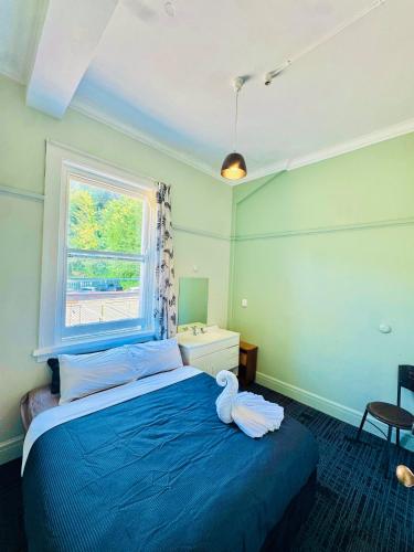 a bedroom with a bed with a stuffed animal on it at Crashpalace Napier in Napier