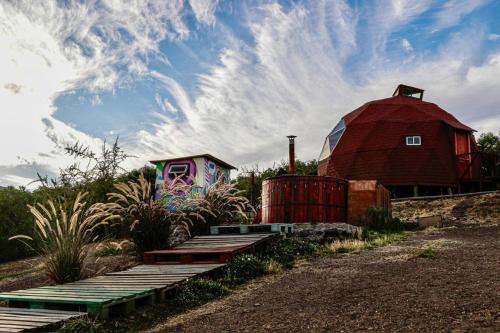 a barn and a red barn with a house at Domos El Llano in Putaendo