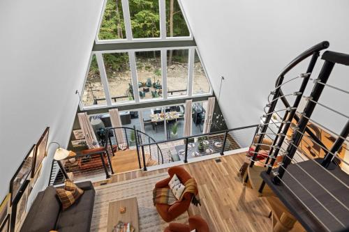 an overhead view of a living room with a spiral staircase at Unique A Frame, Hot Tub, Fire Pit, Cold Plunge in Berkeley Springs