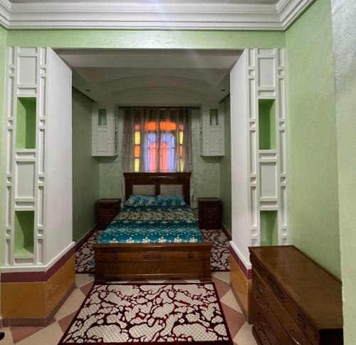 a bedroom with a bed in a room with a window at Moroccan culture Apt! Airport in Marrakech