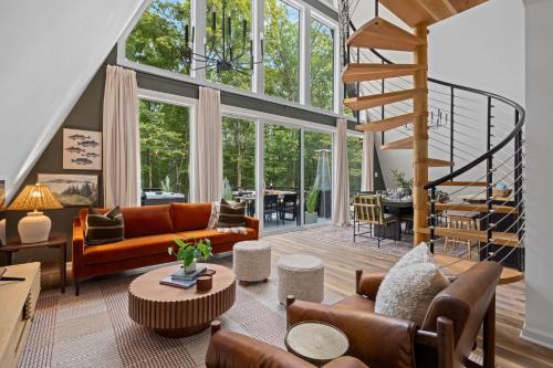 a large living room with a staircase and a living room at Unique A Frame, Hot Tub, Fire Pit, Cold Plunge in Berkeley Springs