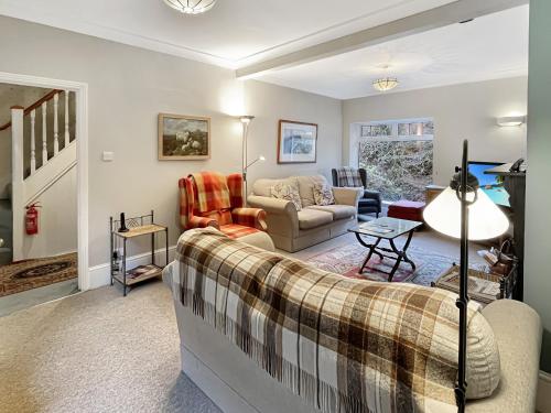 a living room with a couch and a table at River Cottage in stunning location in Countisbury