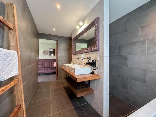 a bathroom with a sink and a mirror at Villa Amore in Alphen