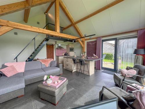 a living room with a couch and a table at Villa Amore in Alphen
