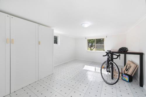 a bike parked in a room with white walls at Adelaide Hills Luxury Cottage - The Gladys in Carey Gully