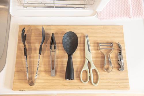 a wooden cutting board with utensils in a drawer at Ocean Front Villa Katsuura やどかり in Kawazu