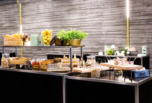 a buffet line with food on top of it at Clarion Hotel Malmö Live in Malmö
