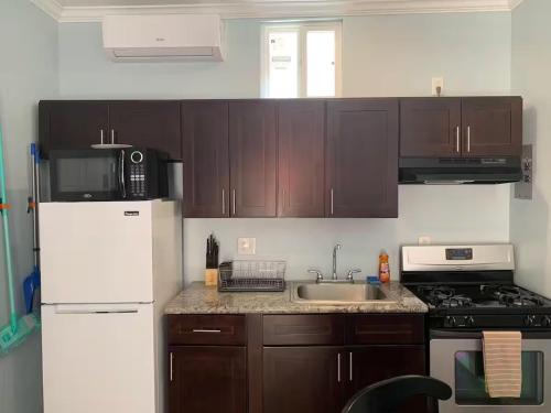 a kitchen with a white refrigerator and a sink at Private Sanctuary in Montebello in Montebello