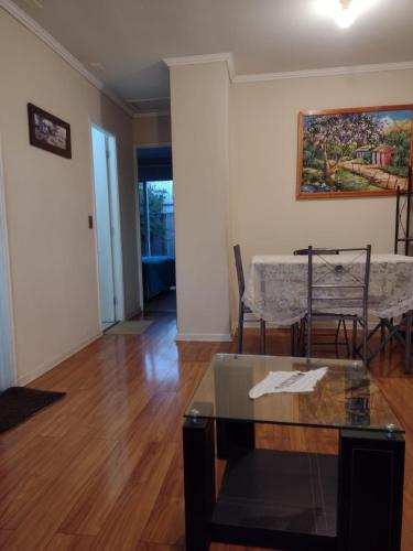 a living room with a table and some chairs at Casa Amayita 2 in Llanquihue