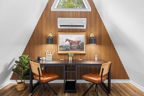 a dining room with a table and two chairs at Unique A Frame, Hot Tub, Fire Pit, Cold Plunge in Berkeley Springs