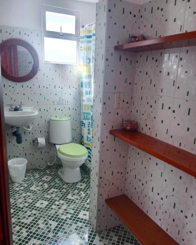 a bathroom with a toilet and a sink at Cabaña Rural BlueHousePaipa in Paipa
