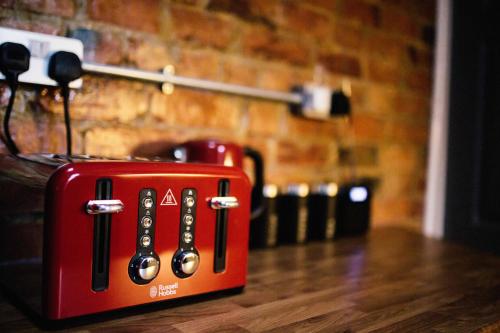 a red toaster sitting on top of a table at Coalminer's Cottage in Gateshead