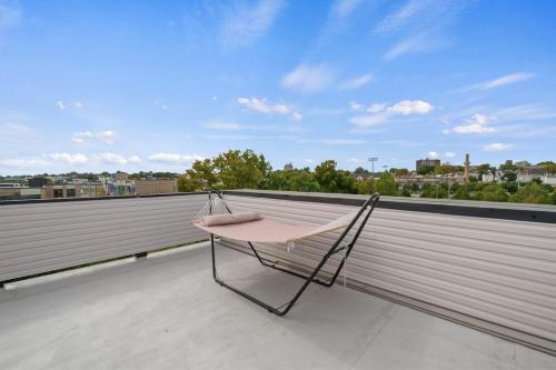 a chair sitting on top of a roof at Sky High Retreat near NYC with Rooftop! in Jersey City