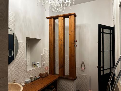 une salle de bain avec un lavabo en bois et un miroir dans l'établissement Les Trois Tilleuls 2, à Loupiac-de-Cadillac