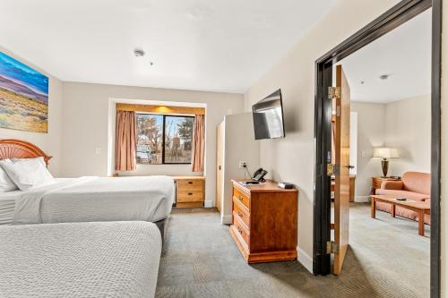a hotel room with two beds and a couch at Days Inn by Wyndham Camp Verde Arizona in Camp Verde