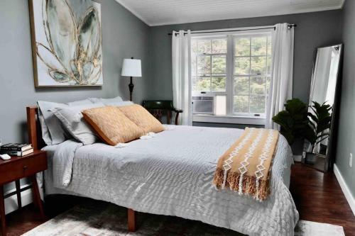 a bedroom with a large bed and a window at Bright, Airy Home in Hudson! in Hudson