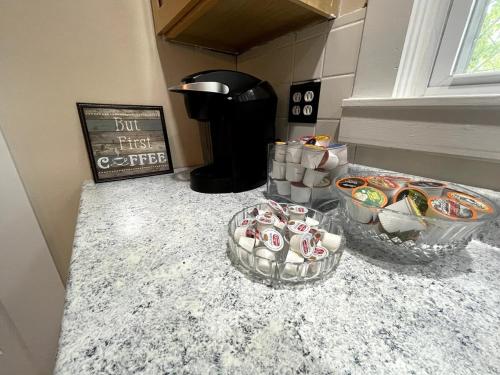 a counter with two bowls of candy on it at Bright, Airy Home in Hudson! in Hudson