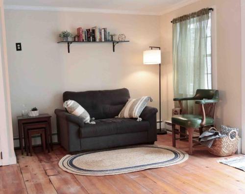 a living room with a couch and a chair at Bright, Airy Home in Hudson! in Hudson