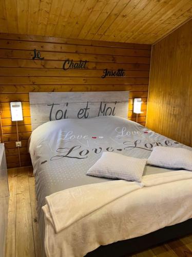 a bedroom with a bed with a sign on it at Escapade et spa Insolite in Saint-Gilles-de-Crétot