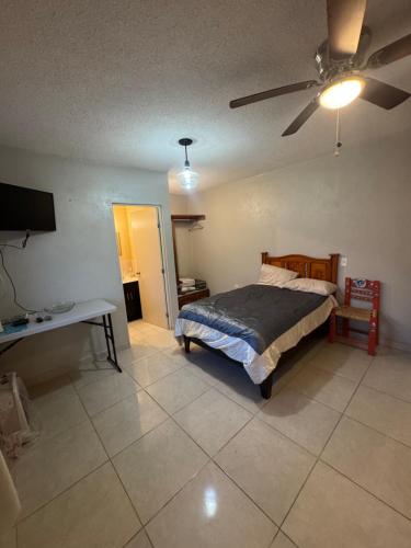 a bedroom with a bed and a ceiling fan at Granja Margarita in Tequisquiapan