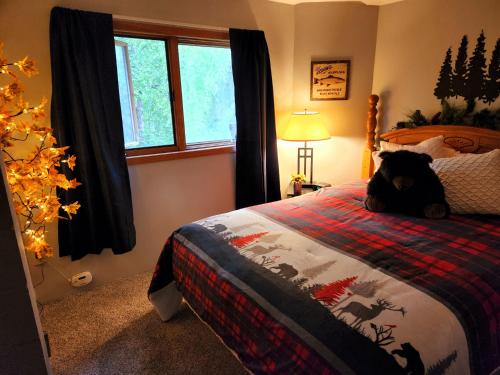 a teddy bear sitting on a bed in a bedroom at Soldotna Alaska 1 bedroom Split Level Guesthouse in Soldotna