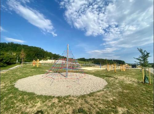 a large playground with a net on the grass at Spacious Cosy Apt with Pool and Parking in Pesnica pri Mariboru