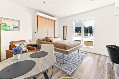 a living room with a bed and a table at Modern Hollywood Studio, Pool Parking Gym in Los Angeles
