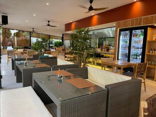 an empty restaurant with tables and chairs and tablesearcher at The Culvert in Kuching