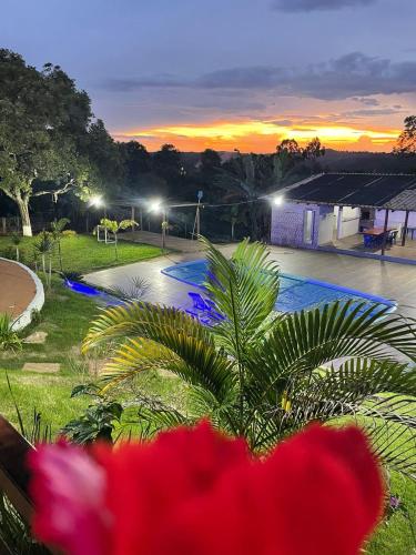 a view of a swimming pool at sunset at Sítio Oásis in Esmeraldas