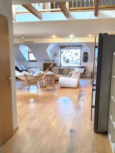 a large living room with a white couch and chairs at Apartment Neratovice in Neratovice