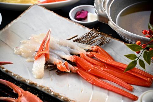 a plate of food with carrots on a table at Tojinbo Mikuni Onsen Ootoku in Sakai