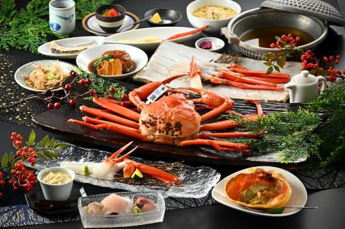 a buffet of food with carrots and other foods at Tojinbo Mikuni Onsen Ootoku in Sakai
